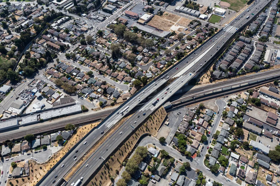 Aerial view of 238 freeway in Oakland, California cutting through neighborhood with small houses